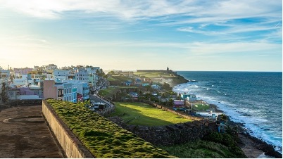 An image of Old San Juan pictured on the left and the shore on the right. 