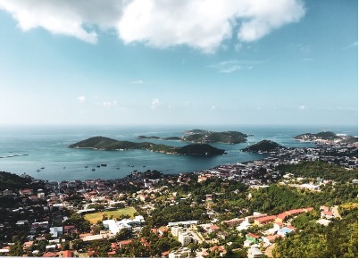 An image where Charlotte Amalie  is pictured in the foreground and the ocean is pictured in the background. 
