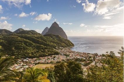 An image of St.Lucia's mountainous landscape and the ocean in the distance on the right. 