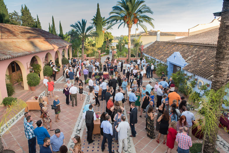 Attendees gather in a courtyard for appetizers and cocktails in Marbella, Spain
