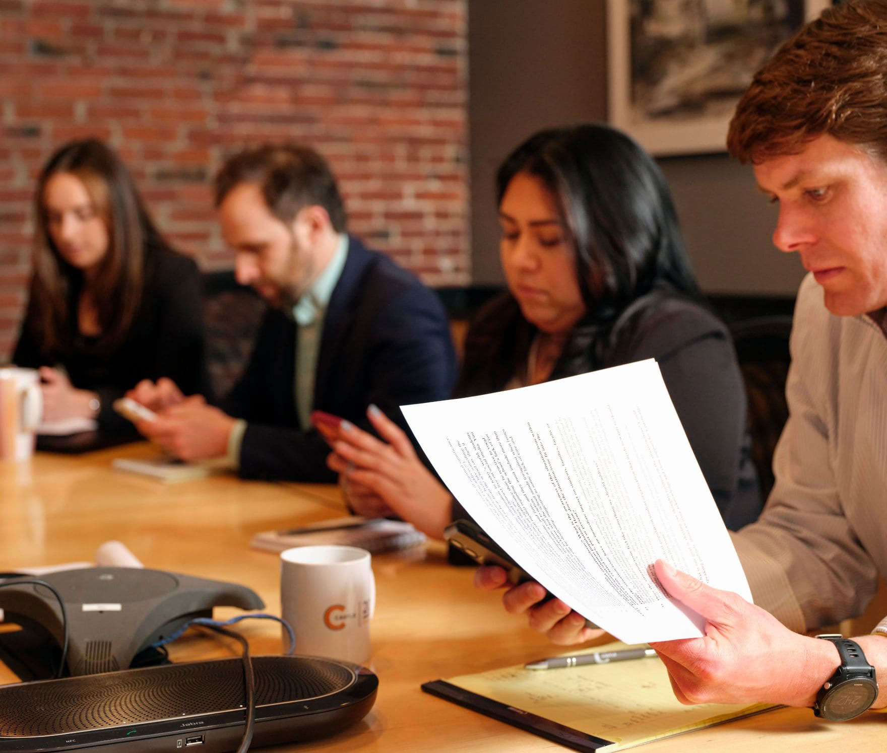 Four Castle team members reviewing documents at the conference room table