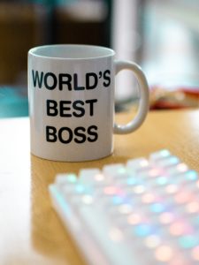 Mug next to keyboard that says "world's best boss"