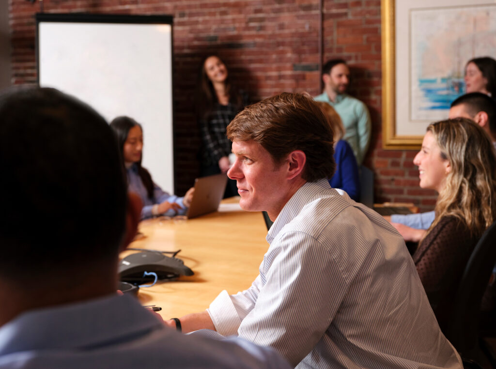 Philip Hauserman and the Castle team sit around the conference table