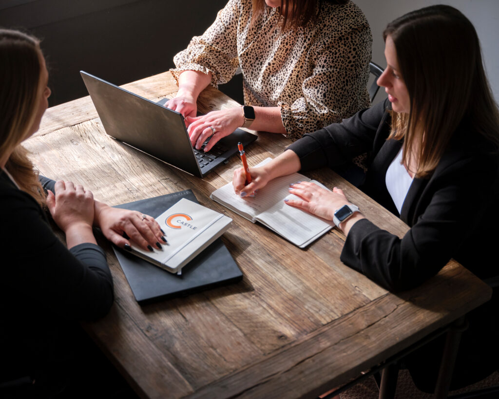 three people meeting at a table