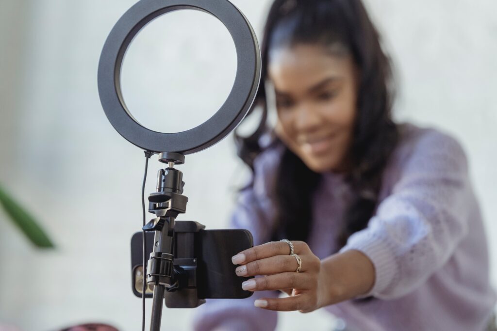 Social Media Influencer taking a photo with her phone and a ring light